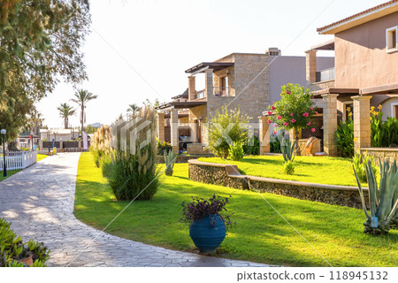Modern buildings on the island of Crete, Greece. Hotel area and luxury tropical apartment resort complex. Modern buildings on the island of Crete, Greece. Hotel area and luxury tropical apartment resort complex. 118945132