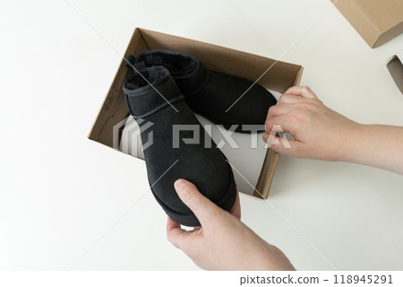 Fashionable modern short UGG boots made of sheep fur for the winter. Fashionable modern short UGG boots made of sheep fur for the winter. 118945291