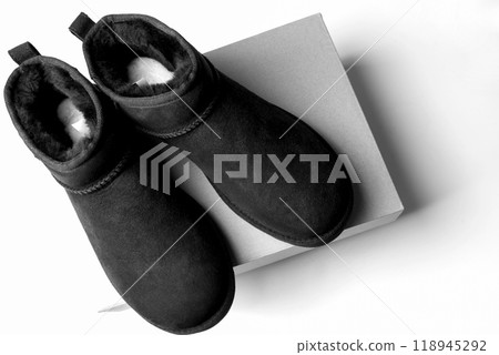 Fashionable modern short UGG boots made of sheep fur for the winter. 118945292