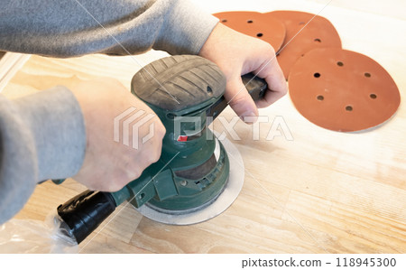 Work with a grinder on wood. Work tool. 118945300