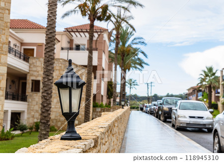 Modern buildings on the island of Crete, Greece. Hotel area and palm trees. Luxury tropical apartment resort complex. 118945310