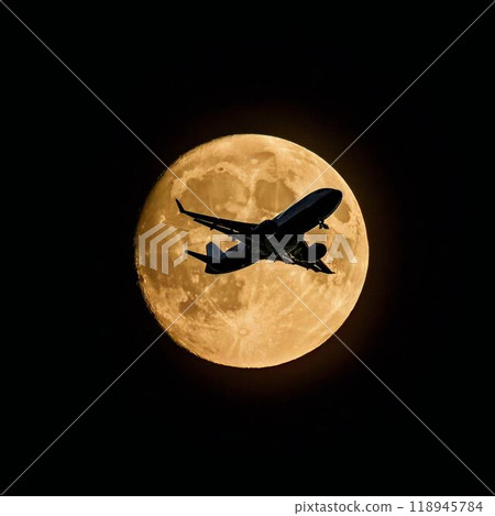 A jet plane flying against the backdrop of a full moon A jet plane flying against the backdrop of a full moon 118945784