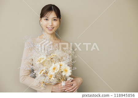 Woman in a beige dress Woman in a beige dress 118945856