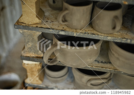 clay mugs in kiln for firing pottery 118945982