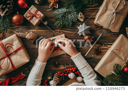 A child and parent craft a festive Christmas tree together, hands engaged in decorating. 118946273