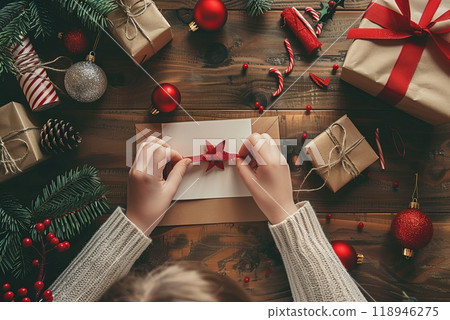 A child and parent craft a festive Christmas tree together, hands engaged in decorating. 118946275