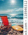 Sunny Seaside Retreat: sun loungers under palm tree on beautiful coastal beach. 118946312