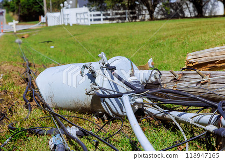 Violent hurricane damaged power lines lie broken on ground as result of storm 118947165