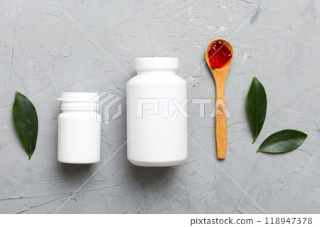 different drugs and health supplement pills with medicine bottle health care and medical top view. Vitamin tablets. Bottle with colored pills on table background. Multivitamins 118947378