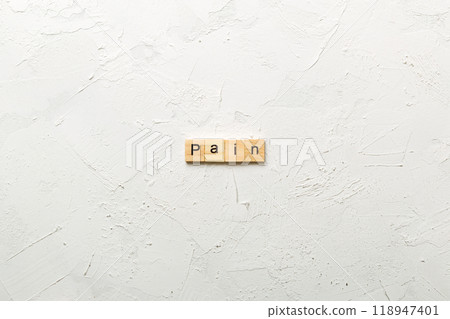 PAIN word written on wood block. PAIN text on cement table for your desing, concept PAIN word written on wood block. PAIN text on cement table for your desing, concept 118947401