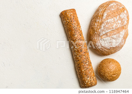 Homemade natural breads. Different kinds of fresh bread as background, top view with copy space Homemade natural breads. Different kinds of fresh bread as background, top view with copy space 118947464