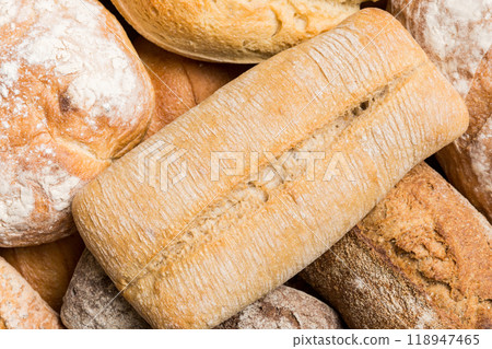 Homemade natural breads. Different kinds of fresh bread as background, top view with copy space Homemade natural breads. Different kinds of fresh bread as background, top view with copy space 118947465