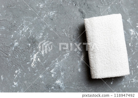 Top view of white towels with copy space on colored background 118947492