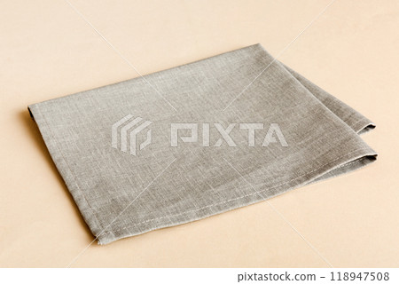 top view with gray kitchen napkin isolated on table background. Folded cloth for mockup with copy space, Flat lay. Minimal style top view with gray kitchen napkin isolated on table background. Folded cloth for mockup with copy space, Flat lay. Minimal style 118947508