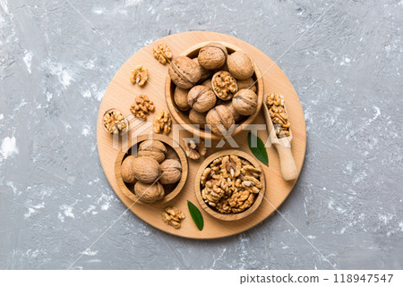 Walnut kernel halves, in a wooden bowl. Close-up, from above on colored background. Healthy eating Walnut concept. Super foods with copy space 118947547