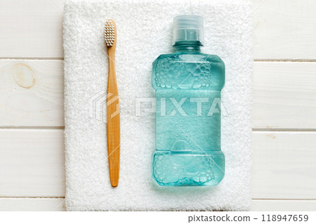 Mouthwash and other oral hygiene products on colored table top view with copy space. Flat lay. Dental hygiene. Oral care products and space for text on light background. concept 118947659