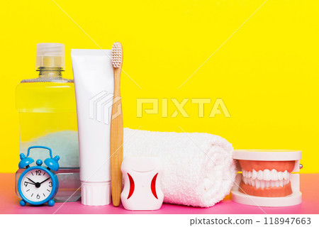 Mouthwash and other oral hygiene products on colored table top view with copy space. Flat lay. Dental hygiene. Oral care kit. Dentist concept Mouthwash and other oral hygiene products on colored table top view with copy space. Flat lay. Dental hygiene. Oral care kit. Dentist concept 118947663