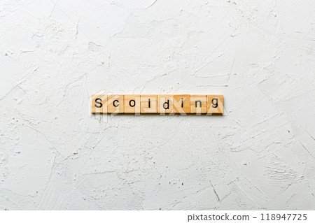 scolding word written on wood block. scolding text on table, concept 118947725