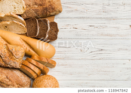 Homemade natural breads. Different kinds of fresh bread as background, top view with copy space Homemade natural breads. Different kinds of fresh bread as background, top view with copy space 118947842