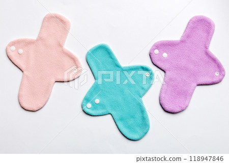 Eco-friendly reusable fabric women's pads. set of colorful bright reusable menstrual pads. zero waste woman periods concept top view with copy space Eco-friendly reusable fabric women's pads. set of colorful bright reusable menstrual pads. zero waste woman periods concept top view with copy space 118947846