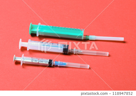 Top view of medical syringes on colorful background with copy space. Injection equipment concept Top view of medical syringes on colorful background with copy space. Injection equipment concept 118947852