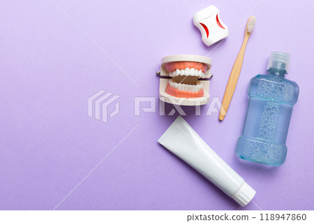 Mouthwash and other oral hygiene products on colored table top view with copy space. Flat lay. Dental hygiene. Oral care kit. Dentist concept Mouthwash and other oral hygiene products on colored table top view with copy space. Flat lay. Dental hygiene. Oral care kit. Dentist concept 118947860