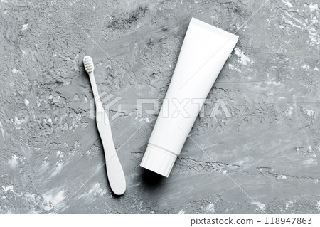 toothpaste and toothbrush top view with copy space on colored background. Flat lay. Dental hygiene. Oral care products on light background. Body care concept 118947863