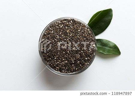 Chia seeds in bowl on colored background. Healthy Salvia hispanica in small bowl. Healthy superfood Chia seeds in bowl on colored background. Healthy Salvia hispanica in small bowl. Healthy superfood 118947897