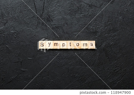 symptoms word written on wood block. symptoms text on table, concept symptoms word written on wood block. symptoms text on table, concept 118947900