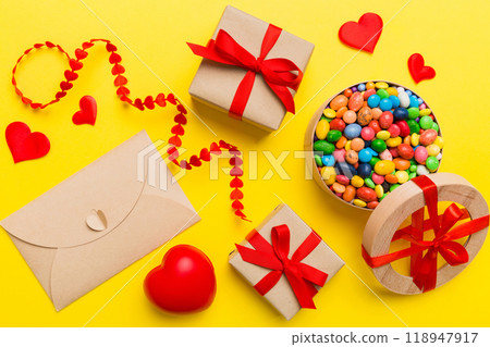 Valentine day composition: sweet candy, with gift boxes with bow and red felt hearts, photo template, background. Top View with copy space 118947917