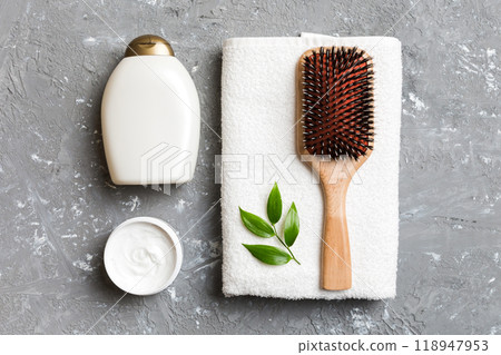 cosmetic for hair care, cream and towel on a colored background top view. flat lay cosmetic for hair care, cream and towel on a colored background top view. flat lay 118947953