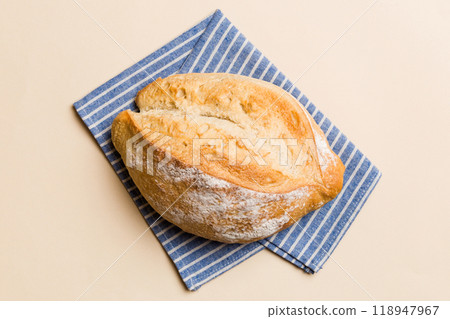 Freshly baked delicious french bread with napkin on rustic table top view. Healthy white bread loaf Freshly baked delicious french bread with napkin on rustic table top view. Healthy white bread loaf 118947967