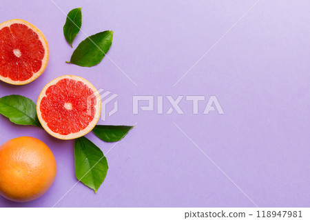 fresh Fruit grapefruit with Juicy grapefruit slices on colored background. Top view. Copy Space. creative summer concept. Half of citrus in minimal flat lay with copy space 118947981
