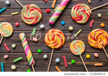Tasty appetizing Party Accessories Happy Birthday Sweet. Different types of candies on colored background, copy space. Colorful birthday party background 118948033