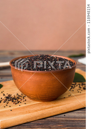quinoa seeds in bowl and spoon on colored background. Healthy kinwa in small bowl. Healthy superfood 118948154