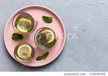 Healthy breakfast or morning with chia seeds lemon and mint on table background, vegetarian food, diet and health concept. Chia pudding with lemon and mint 118948166