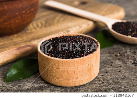 quinoa seeds in bowl and spoon on colored background. Healthy kinwa in small bowl. Healthy superfood 118948167