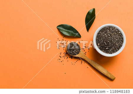 Chia seeds in bowl and spoon on colored background. Healthy Salvia hispanica in small bowl. Healthy superfood 118948183