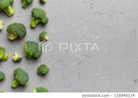 Top view fresh green broccoli vegetable on Colored background. Broccoli cabbage head Healthy or vegetarian food concept. Flat lay. Copy space Top view fresh green broccoli vegetable on Colored background. Broccoli cabbage head Healthy or vegetarian food concept. Flat lay. Copy space 118948334