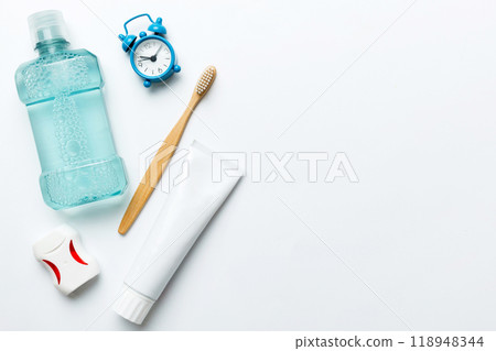 Mouthwash and other oral hygiene products on colored table top view with copy space. Flat lay. Dental hygiene. Oral care products and space for text on light background. concept 118948344
