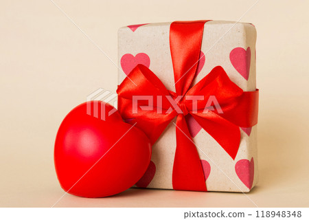 gift box with red bow and red heart on colored background. Perspective view. Flat lay 118948348