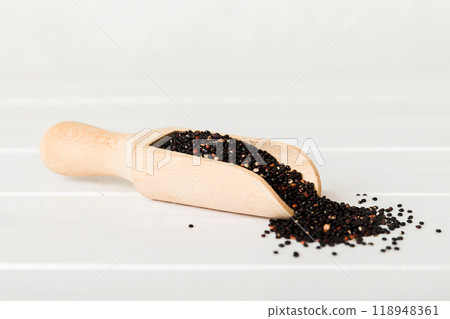 quinoa seeds in spoon on colored background. Healthy kinwa in small spoon. Healthy superfood quinoa seeds in spoon on colored background. Healthy kinwa in small spoon. Healthy superfood 118948361