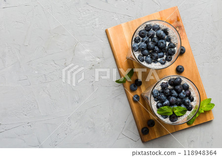Healthy breakfast or morning with chia seeds vanilla pudding and blueberry berries on table background, vegetarian food, diet and health concept. Chia pudding with coconut milk and blueberry 118948364