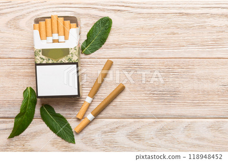 Pack of menthol cigarettes and fresh mint on colored table, Menthol cigarettes top view flat lay 118948452