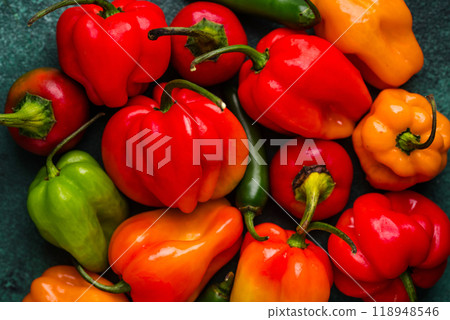 Colorful peper on green background Colorful peper on green background 118948546