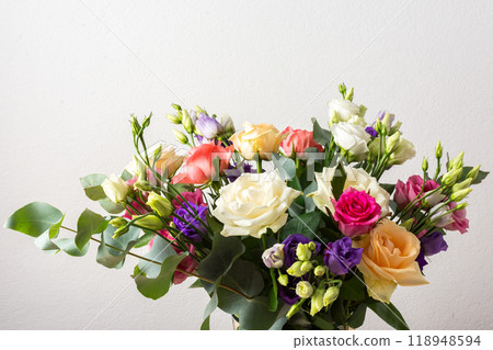 Celebrate special occasions with a colorful summer bouquet featuring fresh roses, eucalyptus, and eustoma blooms, creating an elegant and fragrant floral arrangement Celebrate special occasions with a colorful summer bouquet featuring fresh roses, eucalyptus, and eustoma blooms, creating an elegant and fragrant floral arrangement 118948594