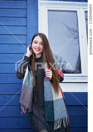 portrait of a young woman with long blond hair in a light dress in winter by  blue barn 118948664