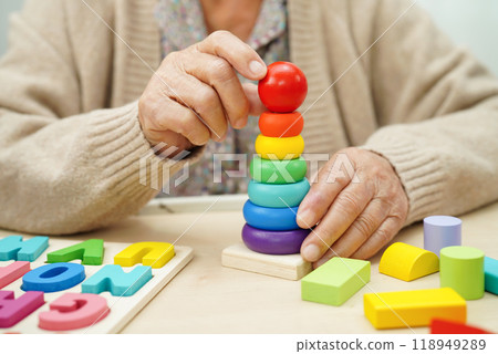 Asian elderly woman playing game. 118949289
