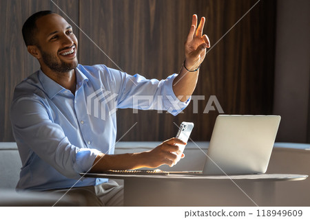 Man using laptop and smartphone in cafe while making ordering 118949609