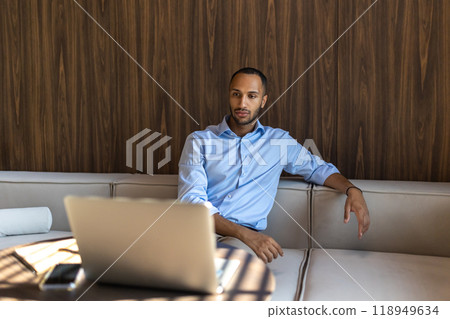 African American businessman working inside modern office with laptop 118949634